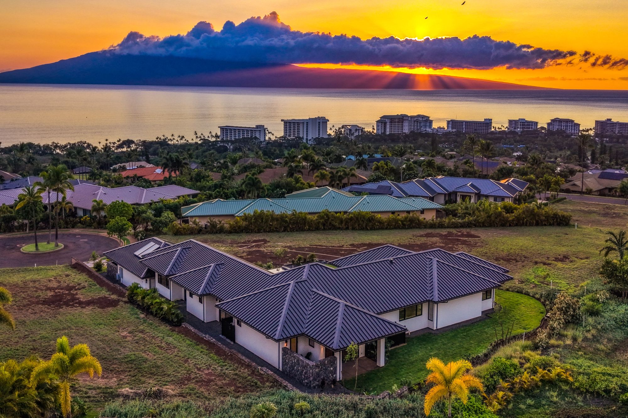 Aerial at sunset over Kāʻanapali toward Lānaʻi
