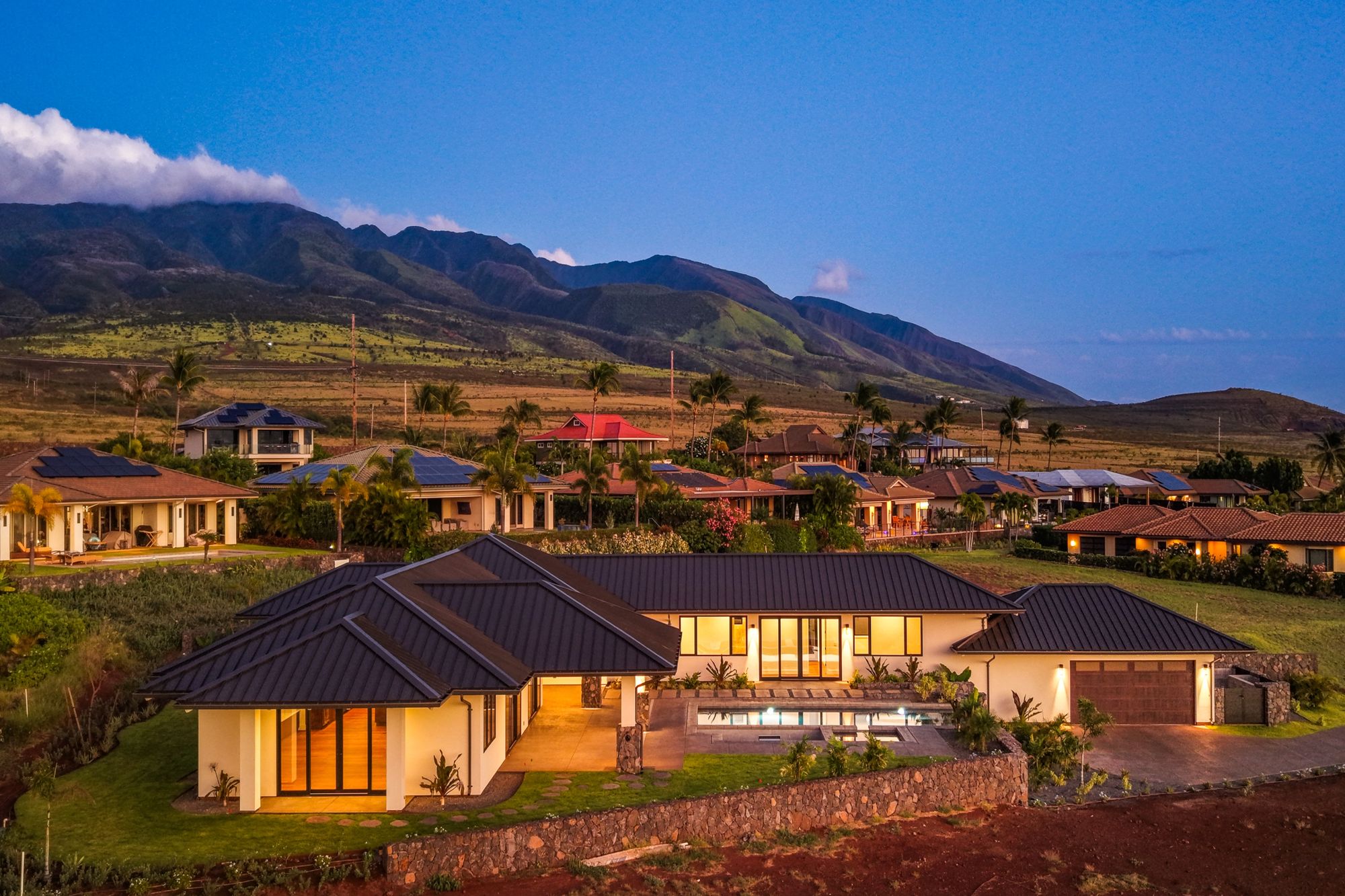The residence at dusk beneath the West Maui Mountains